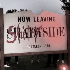 two horses standing in front of a sign that says now leaving shadyside