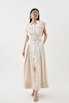 Elegant Styling Meets Timeless Tailoring For This Perfectly-Proportioned Hybrid Design, Crafted From Lightweight Linen That Beckons To Summer Styling. This Maxi Dress Is Structured With Classic Details, Including Wide Shoulders That Create Soft Drapes To The Button-Up Bodice, Offset By A Belted Waist And Inverted Pleats.Point Collarbuttoned Placketchest Pocketsbelted Waistmaxi Length Sleeveless Shirt Dress Outfit, Elegant Styling, Latest Maxi Dresses, Wide Shoulders, Shirt Dress Outfit, Maxi Dress Collection, Summer Styling, Sleeveless Shirt Dress, Summer Linen Dresses