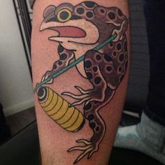 a frog with a bee on it's leg and an arrow in its mouth