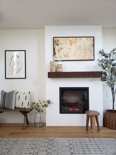 a living room filled with furniture and a fire place in the middle of the room