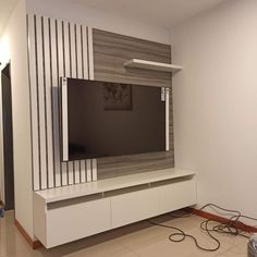 a flat screen tv sitting on top of a white entertainment center