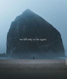 a man standing on top of a sandy beach next to a large rock with the words we fall only to rise again