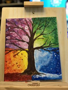 a painting on a wooden easel with a tree painted on it