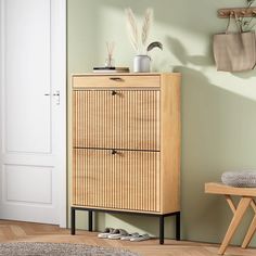 a wooden cabinet sitting next to a white door