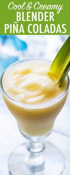 a close up of a drink in a glass with a green garnish on top