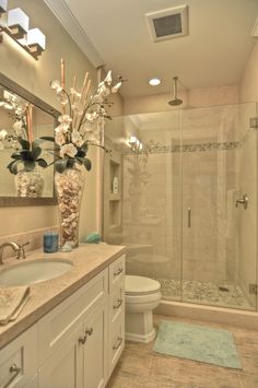 a bathroom with a sink, toilet and shower