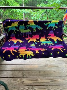 a colorful blanket sitting on top of a wooden deck