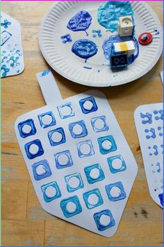 paper plates with blue and white designs on them, next to a crafting kit