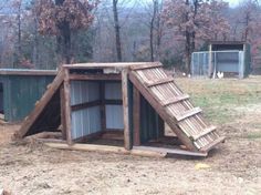 two chicken coops in the middle of a field