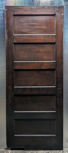 a close up of a wooden door on a wall