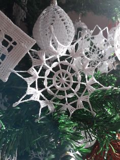 white snowflakes hanging from a christmas tree