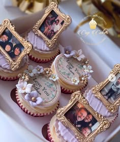 four decorated cupcakes with pictures on them sitting in a white box next to gold foil