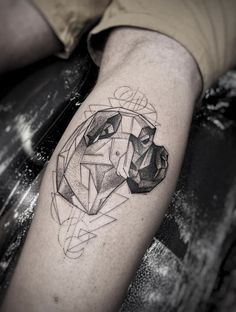 a man's arm with a geometric tattoo design on the left side of his leg