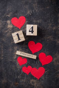 wooden cubes with numbers and hearts on them sitting in front of the number four