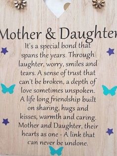 a wooden plaque with the words mother and daughter written on it, surrounded by butterflies