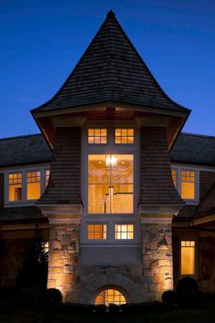 a large house lit up at night with lights on