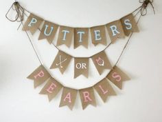 two bunting banners that say putters or pearls and are hanging on the wall