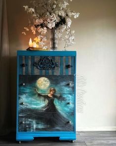 a blue cabinet with an image of a woman on it and flowers in the background