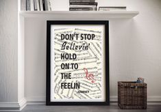 a framed poster with the words don't stop believing, hold on to the feeling