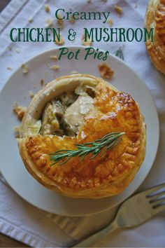 a chicken and mushroom pot pie on a white plate with a fork next to it