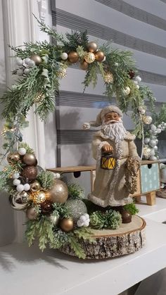 a christmas decoration is displayed on a shelf in front of a window with a wreath