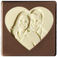 a chocolate heart with a couple's face carved into it