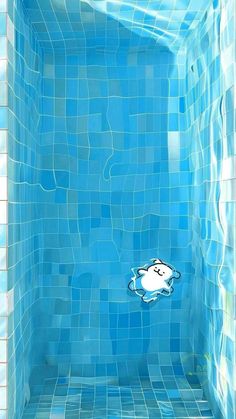 a blue tiled shower with a cartoon character floating in it