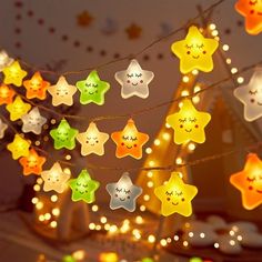 star shaped lights hanging from strings in the shape of stars with smiling faces on them