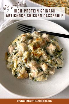 a white plate topped with chicken and spinach casserole next to a fork