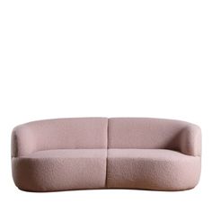 a pink couch sitting on top of a white wall