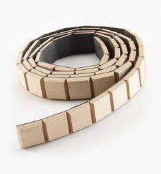 a close up of a wooden belt on a white background with no people around it