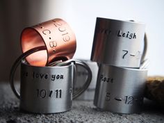 three stainless steel rings with numbers on them sitting next to each other and one has a ring in the middle that says, i love you