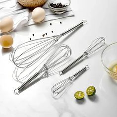 several kitchen utensils and ingredients on a white counter top, including an egg