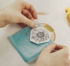 someone is making a flower stamp on a piece of paper