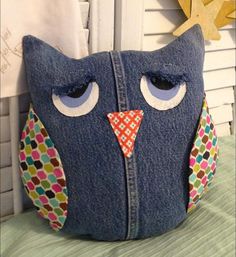 an owl pillow is sitting on a bed