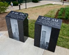 two black and white memorial boxes sitting on top of a sidewalk