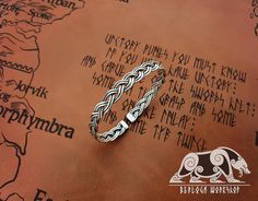 a silver bracelet sitting on top of a map