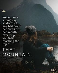 a woman sitting on top of a lake next to a mountain with a quote above it