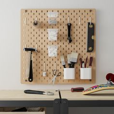 a peg board with scissors and other office supplies on it