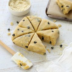 blueberry cheesecakes cut into triangles on a cutting board next to a bowl of oatmeal