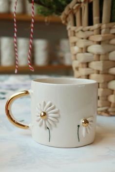 a white coffee cup sitting on top of a table