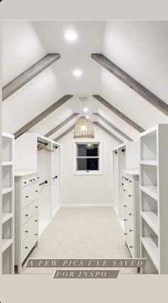 an attic bedroom with white walls and shelving units on the ceiling, along with carpeted flooring