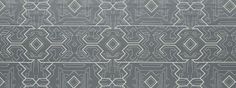 a gray and white area rug with an abstract design