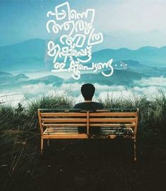 a man sitting on top of a wooden bench under a sky filled with white clouds