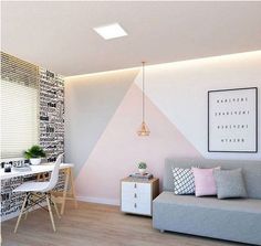 a living room with a couch, table and chair next to a wall that has letters all over it