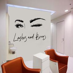 two chairs in front of a white wall with lashes and brows written on the wall