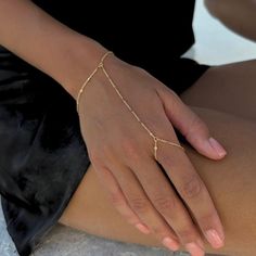 Our BEST SELLING hand chain is so flattering and comfortable to wear. Our 18K gold plated chain is sparkly and sits so beautifully on the hand. Layer with some of your favourite rings and bracelets. We have always been obsessed with hand chains so we created our own. Hand chains are so dainty and give that extra sparkle and shine to your hands. SILVER HAND CHAIN AVAILABLE HERE! - https://minkksi.etsy.com/listing/1104874189 MATCHING LARIAT/Y NECKLACE HERE! - https://minkksi.etsy.com/listing/17093