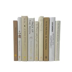 a row of books sitting on top of each other in front of a white background