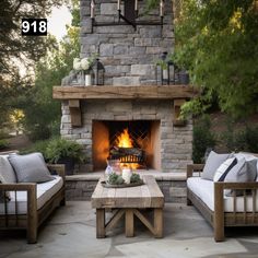 an outdoor fireplace with two couches and a coffee table