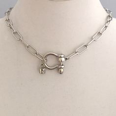 Carabiner Chain Necklace-Choker Necklace-Clasp Chain Necklace-Silver Cable Necklace-Silver Shackle Necklace-Shackle Jewelry-Padlock Charm  A beautiful shiny silver chain made up of paperclip links. The chain is brass and has several plating coatings of color to give the silver electroplated finish.   It is a high quality chain choker chain. The anchor shackle clasp gives the necklace a modern and unusual edge.  It is Silver Plated - Rhodium Plated. Size 21 x 25 mm  To finish off this neck shackle  I added a small CZ padlock with a CZ bail. The padlock also features a CZ star. If you look at the pictures you can see that the shackle clasp unscrews and the chain link is easily navigated both off and onto the shackle. This is a modern and versatile necklace.  Very much on trend. An added feat Choker Chain, Necklace Clasps, The Anchor, Chain Choker Necklace, Trombone, Keep Jewelry, Silver Chain Necklace, Chain Choker, Shiny Silver